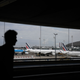 A traveller walks in the Terminal 2 corridors of the Roissy-Charles de Gaulle airport, in the northeastern outskirts of Paris, on September 16, 2022, amid a strike of air traffic controllers. At least one thousand flights have been cancelled as a consequence of the strike called by the SNCTA air controller union, also disturbing the European air traffic, according to the DGAC